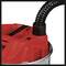 A red industrial vacuum cleaner with a black hose is mounted on a metal base, ready to clean large areas.