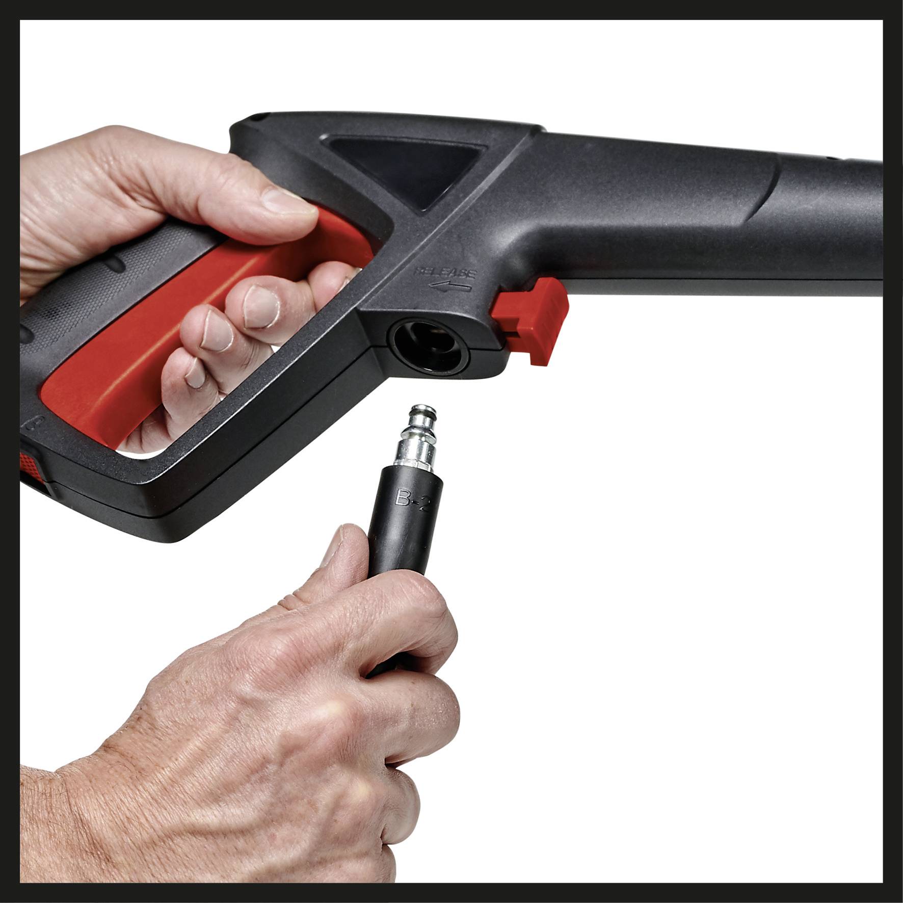 Hands are holding a black high-pressure cleaner handle and attaching a metal connection. The focus is on the connection technique.