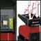 Red Einhell wood chipper with on/off switch on the left, with a branch symbol above indicating operational status, designed for garden waste.