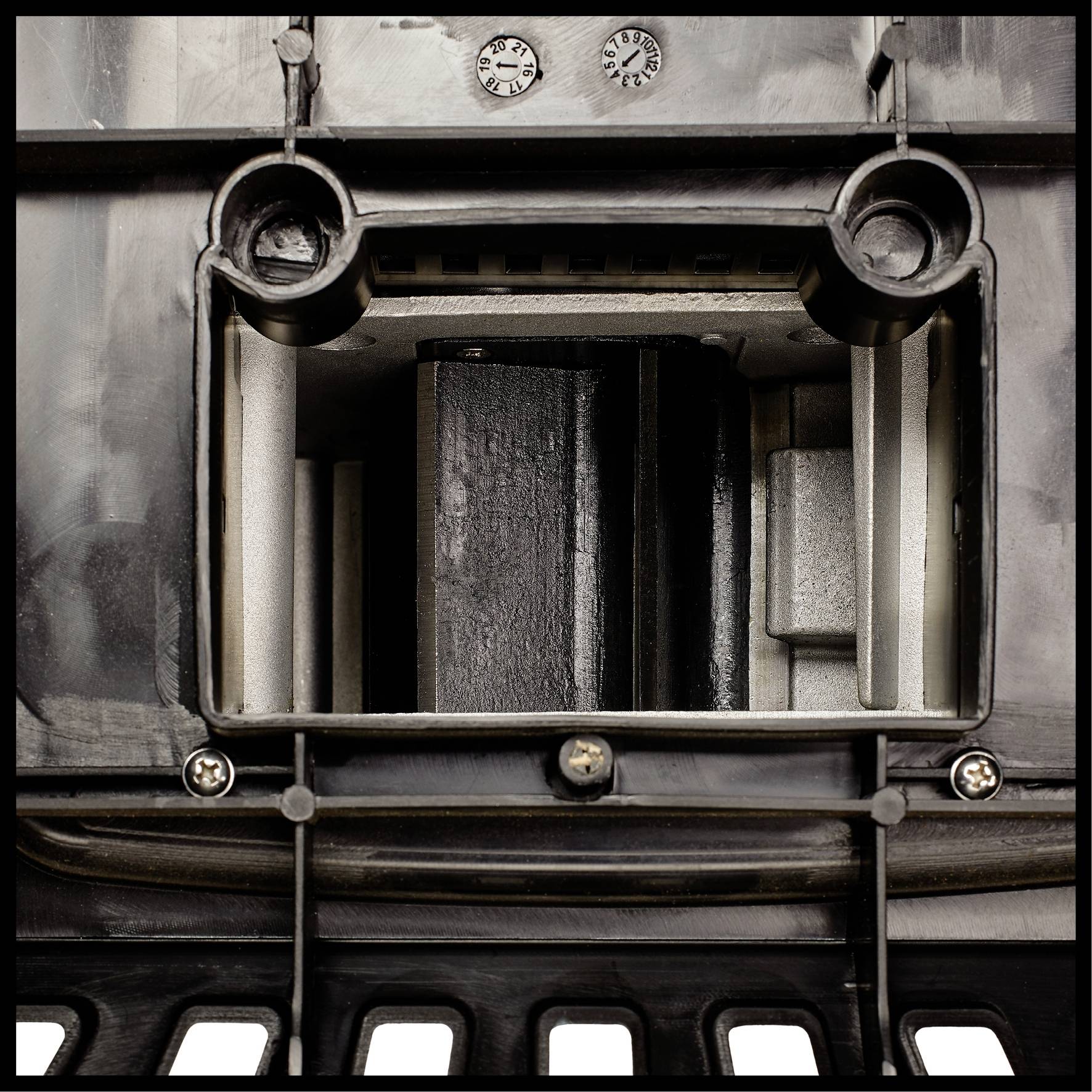 A complex industrial component with a rectangular opening in the centre, flanked by vertical and horizontal structures.