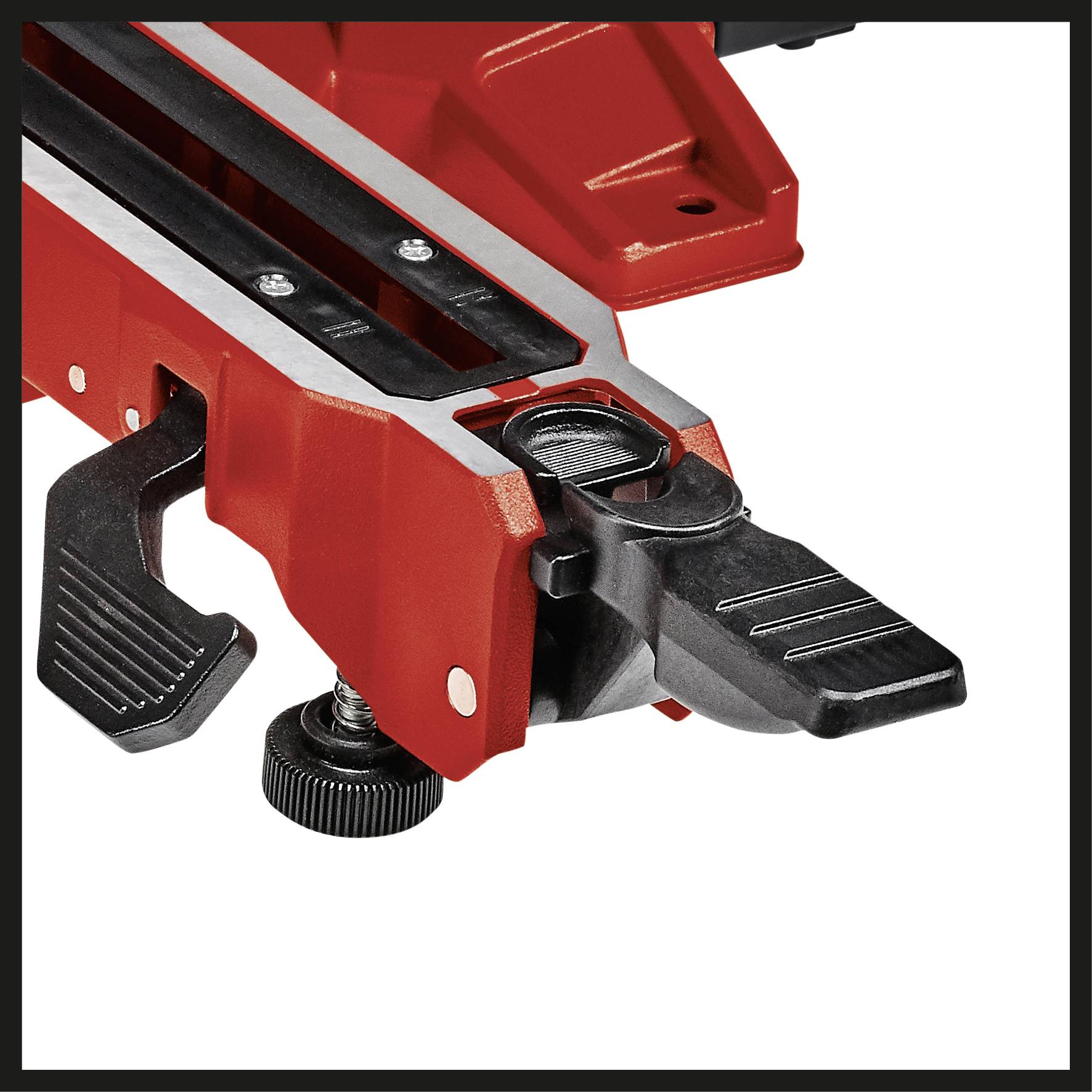 Red and black mounting of a machine with a screw mechanism and lever for precise adjustments.