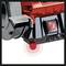 A red electric grinding tool with a protective cover and main switch turned on. Suitable for grinding work.