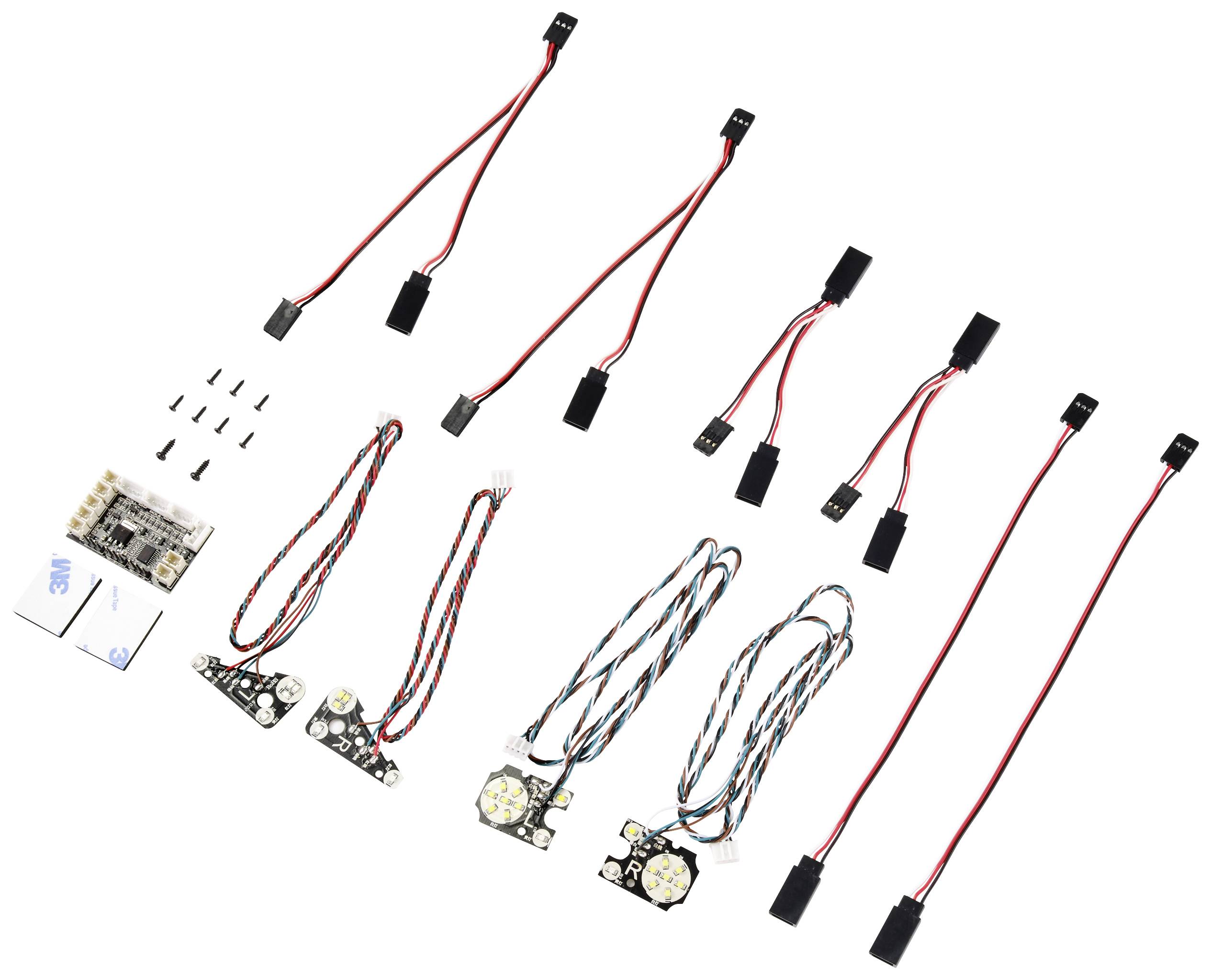Kit for an electronics project with various cables, connectors, and circuits, spread out on a white background.