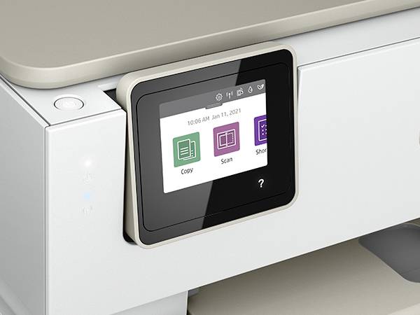 A modern printer with a touchscreen displays options: 'Copy', 'Scan' and 'Send'. The screen shows the time and date.