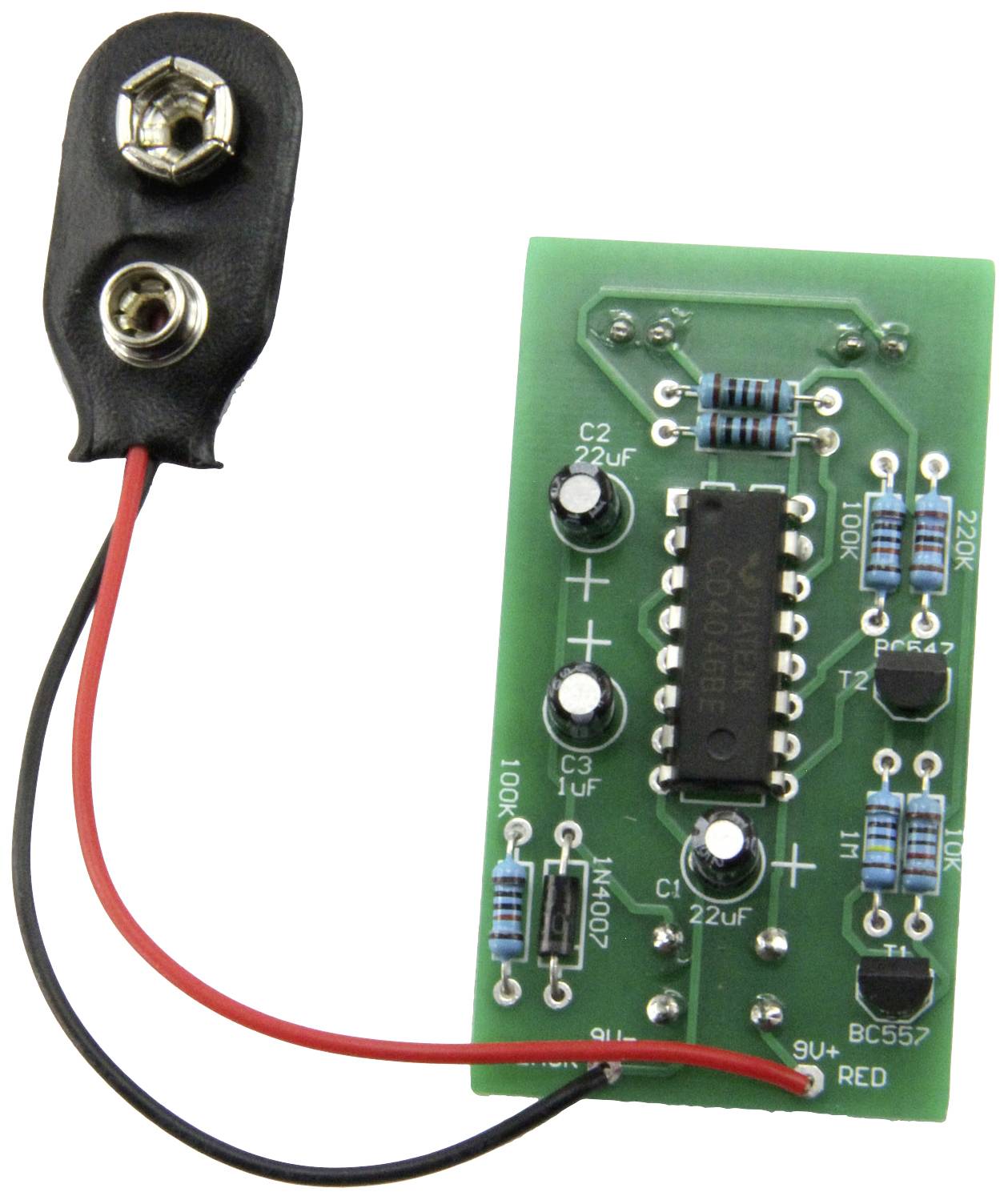 A green electronic circuit with various resistors, an IC chip, and a battery connection on the left side.