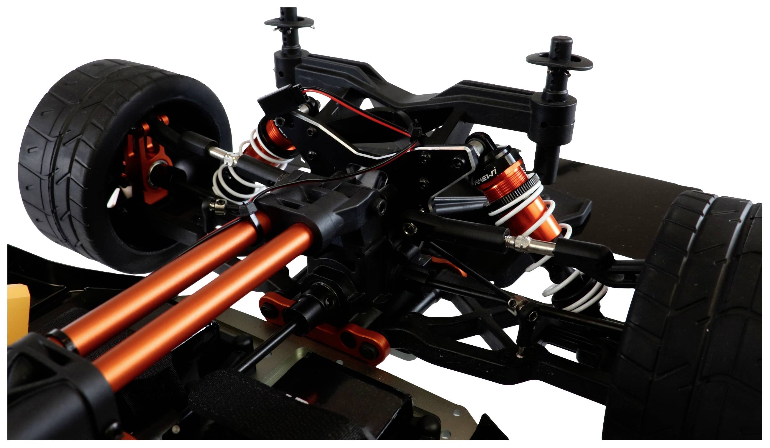Close-up of a remote-controlled car's rear axle with stabilisers and suspension in black and orange.