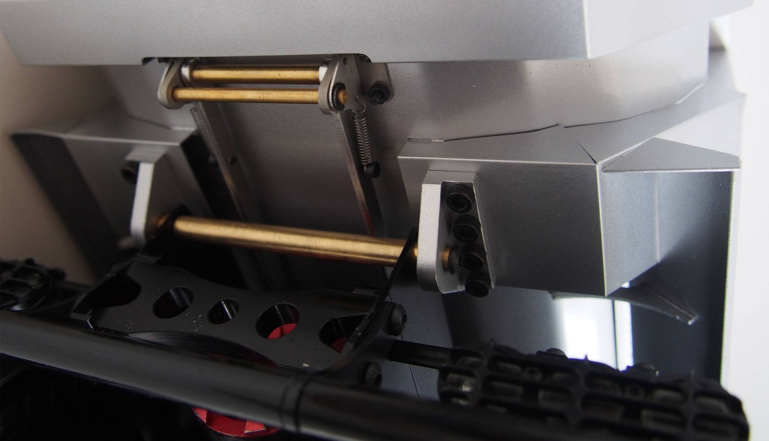 A metal industrial or mechanical engineering component with multiple rods and screws, shown in detailed view.