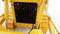 Yellow robotic arm in close-up, showing mechanical parts and cables. Focuses on the technical detailed view and construction.