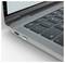 Close-up of a laptop corner showing the keyboard, speaker grille, and side USB-C port on a silver-gray body.