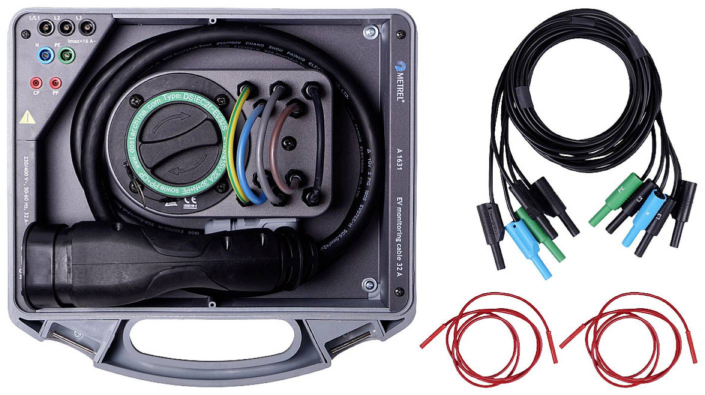 A measuring device in a case with cables and clips, used for electrical testing. Separate test cables are lying to the right.