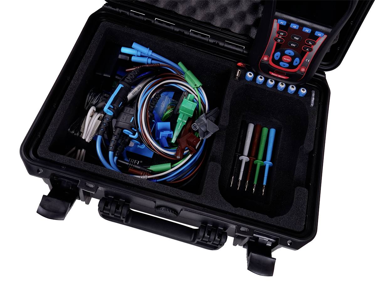 An open tool case with cables, measuring instruments, and accessories for vehicle diagnostics.