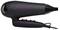 A black hairdryer with purple switches and a coiled cable.
