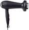 A black hairdryer with a diffuser attachment, model 'Tristar Ionic', stands sideways with its mains cable visible and pink control buttons.