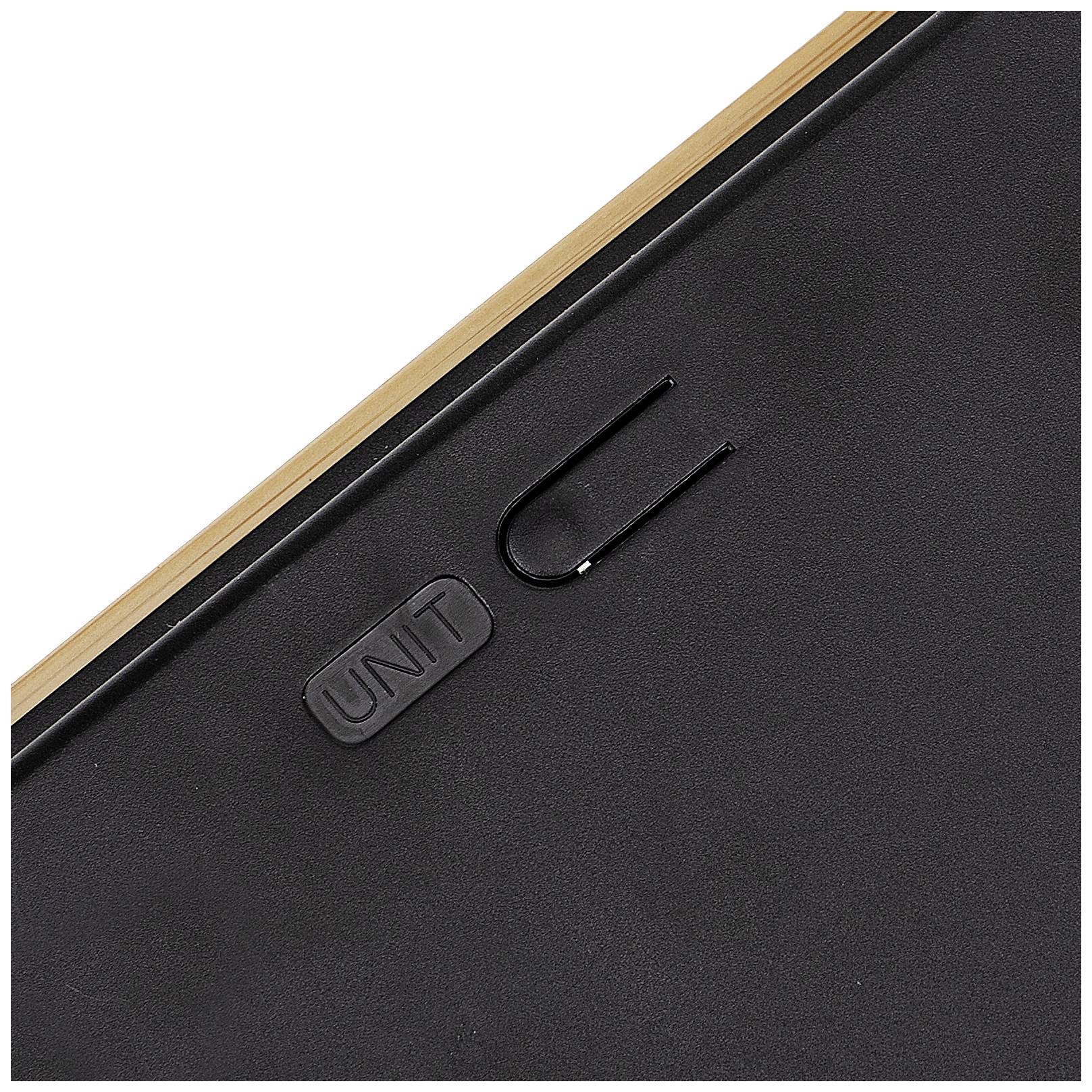 Black surface with a clip and engraving 'UNIT' on wooden frame.