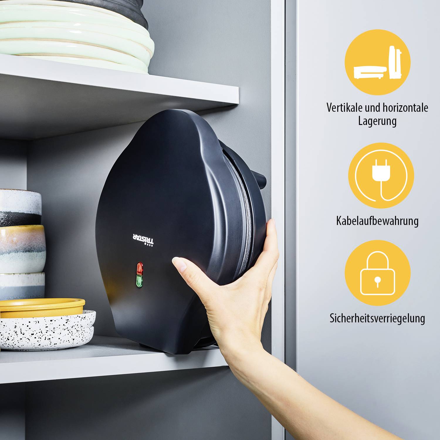 A waffle iron is stored vertically in a shelf. Text on right: 'Vertical and Horizontal Storage', 'Cable Storage', 'Safety Lock'