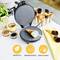 Waffle iron on kitchen table with baked croissant and bowls. Pictured are symbols: BPA/PFOA-free, non-stick, easy to clean.