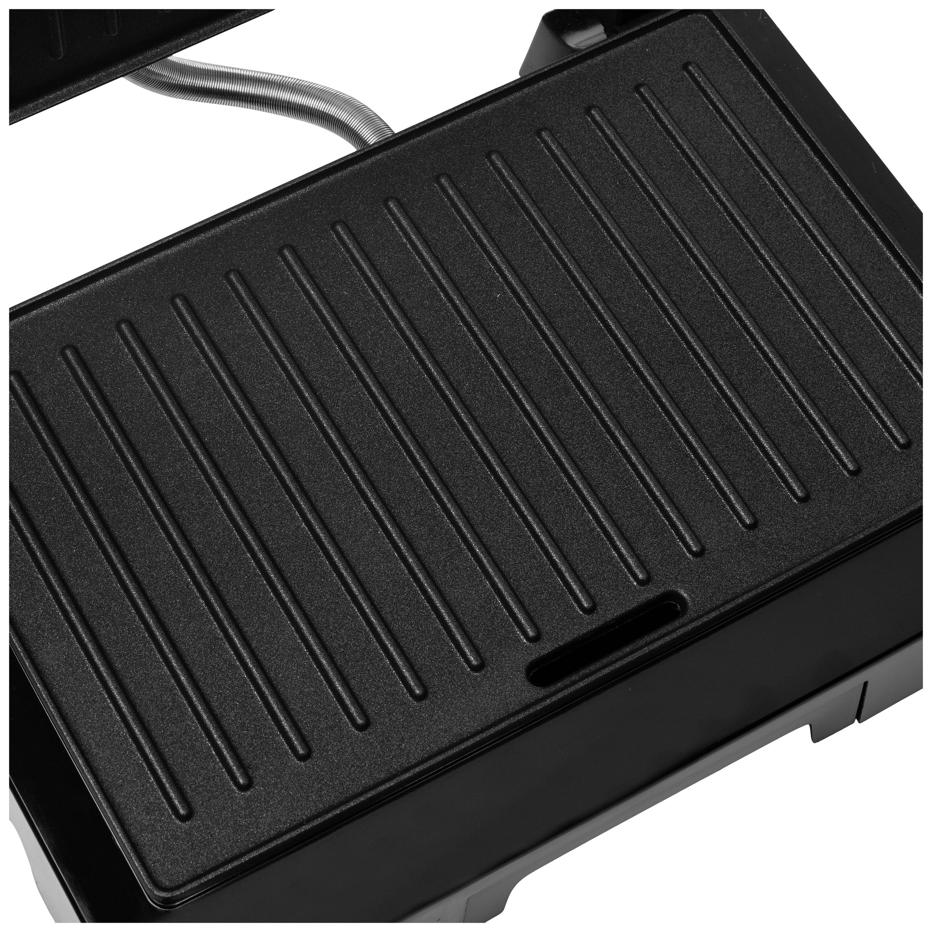 A black grill with a ridged surface is shown. The grill has a slot for fat drainage and is electronic.