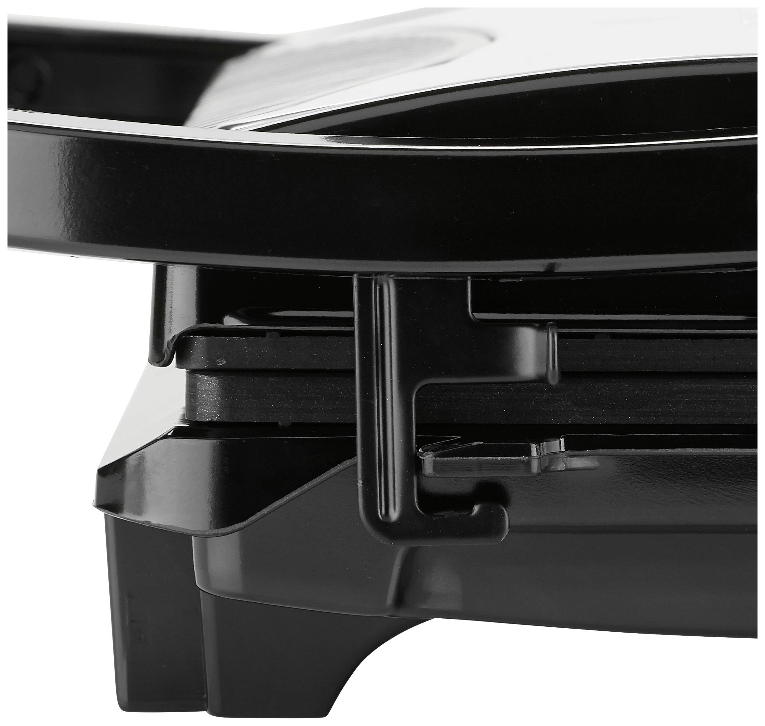 Close-up of a black electric grill viewed from the side, revealing the hinges and pressing mechanism. No food visible.