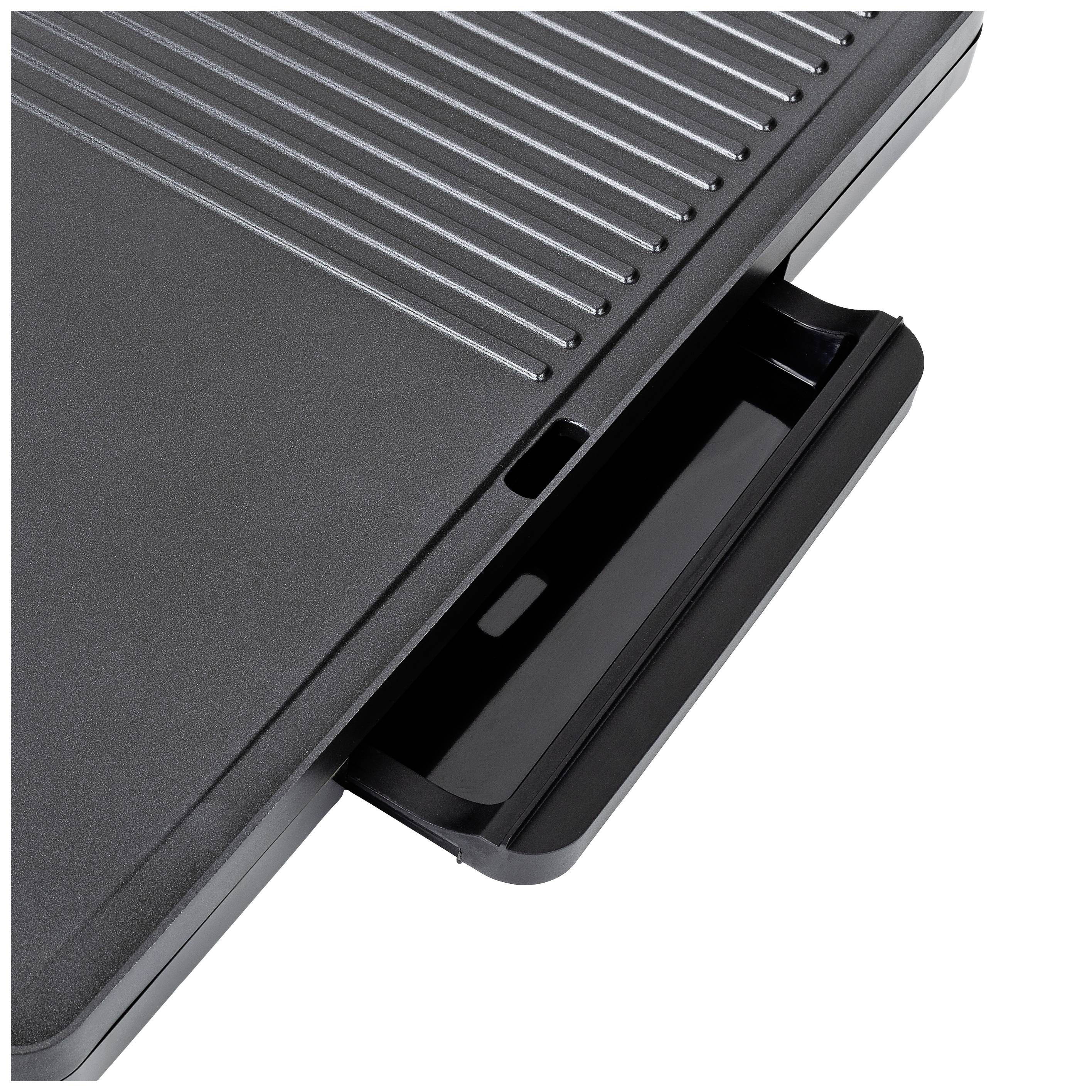 A close-up of an electric grill with an extended grease collection tray. The grill plate shows grooves for fat drainage.