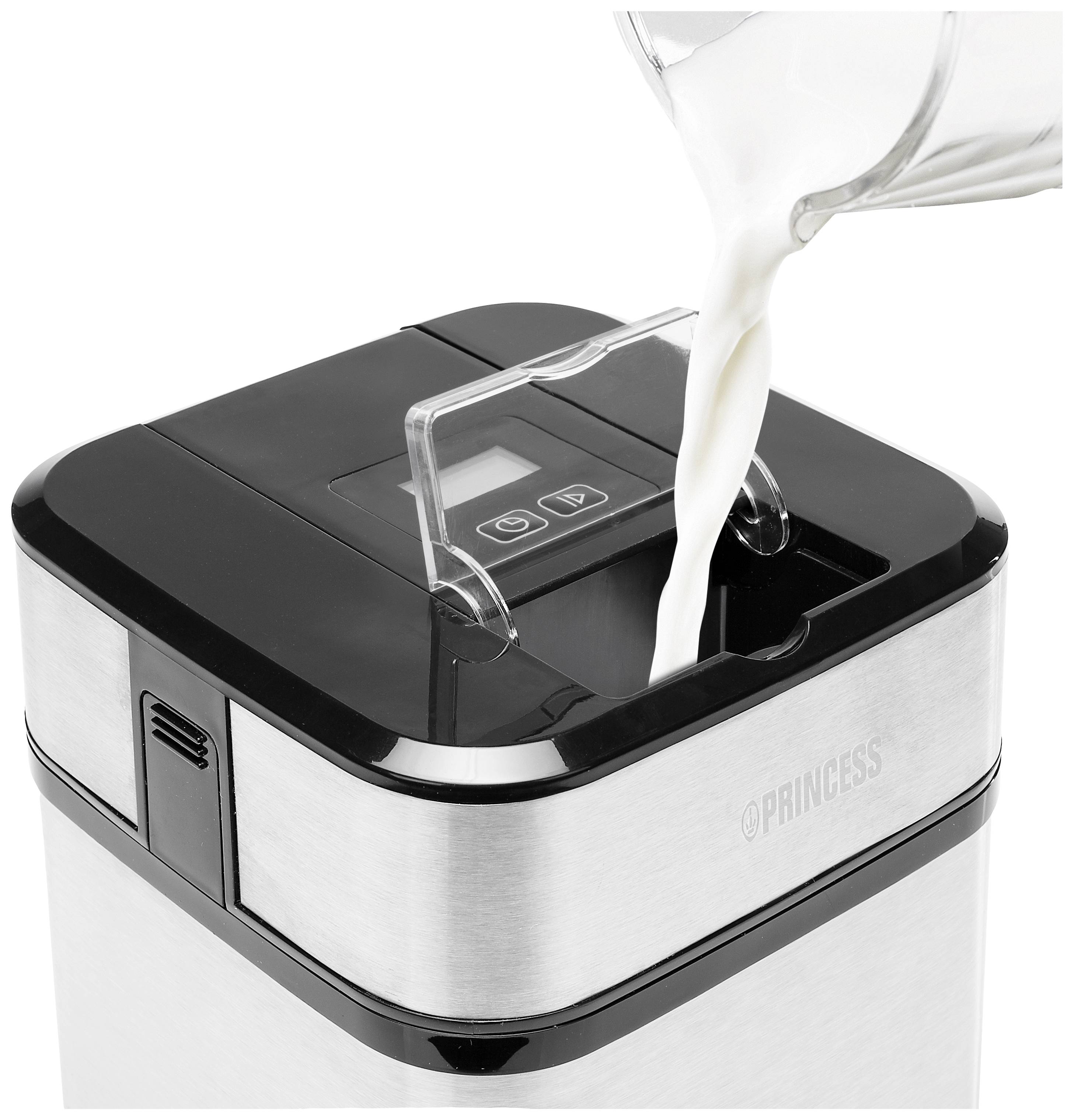 A stainless steel ice cream maker with a digital display is being filled with milk from a jug.