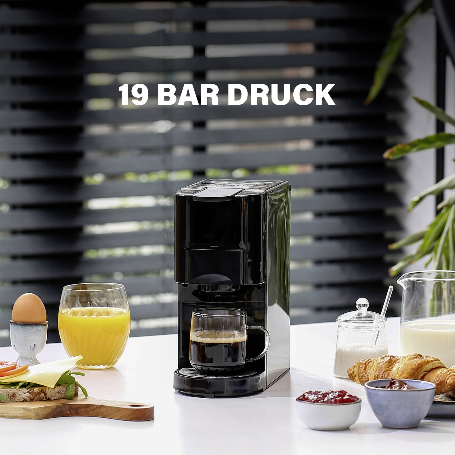 Coffee machine on a table with juice, eggs, and pastries. Text '19 Bar Pressure' highlights the pressure of the coffee machine.