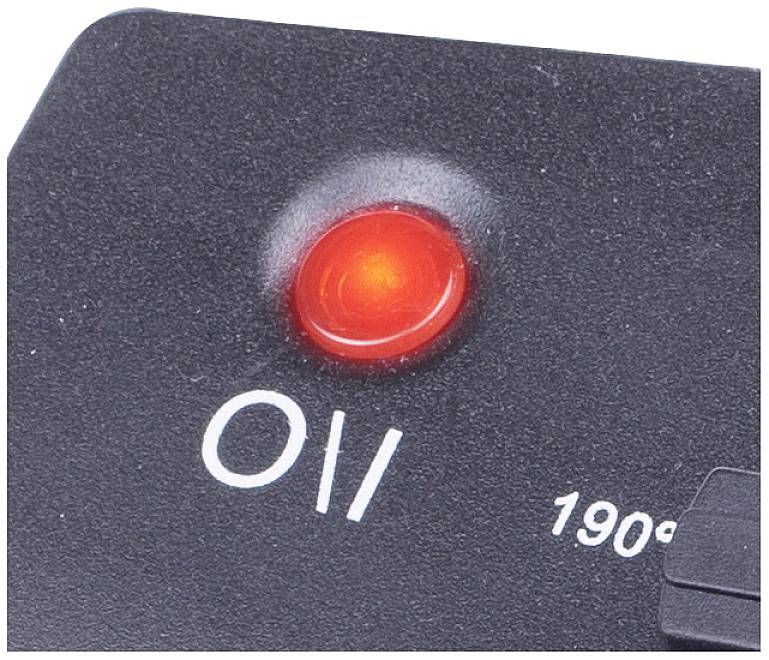 Red, illuminated on/off switch on a black background, close-up.