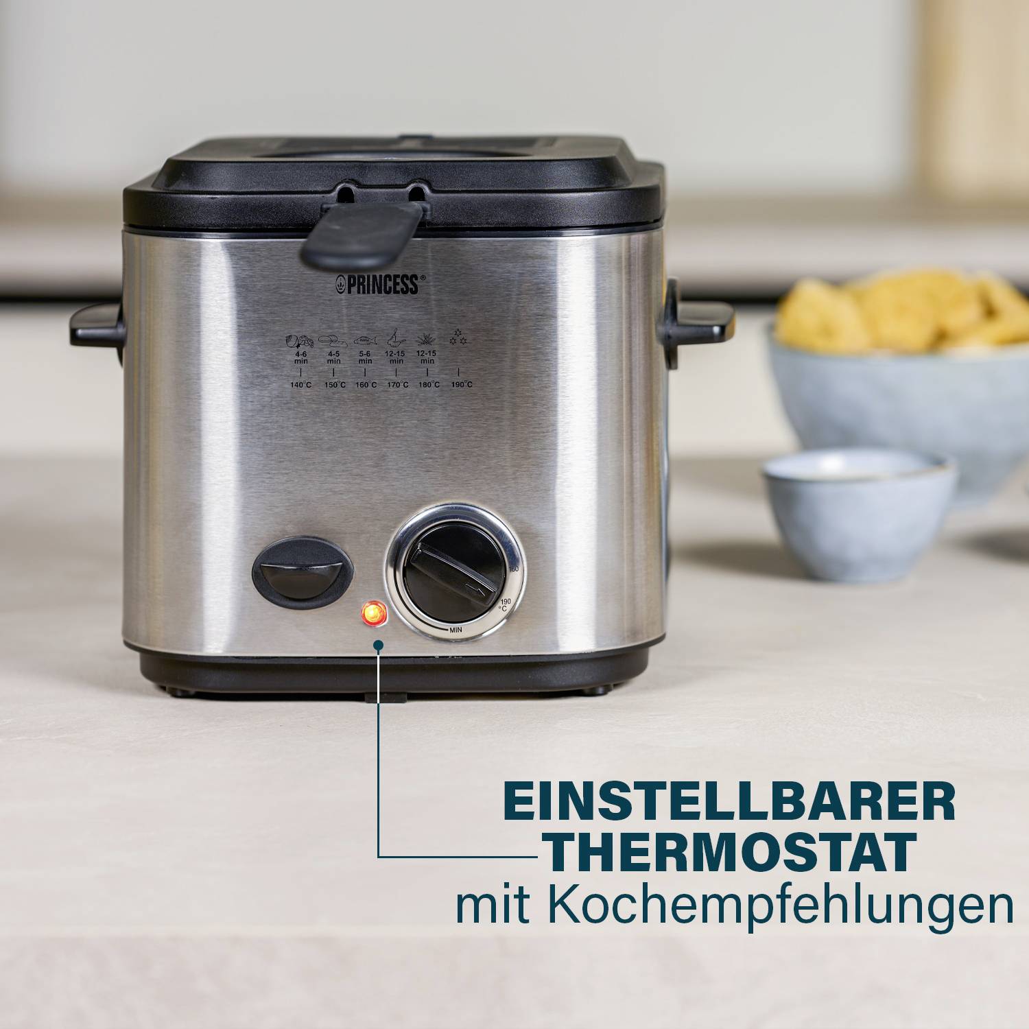 A silver deep fryer on a kitchen worktop, with an adjustable thermostat and cooking tips displayed in text alongside.