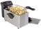 A stainless steel deep fat fryer with a basket full of freshly fried chips.