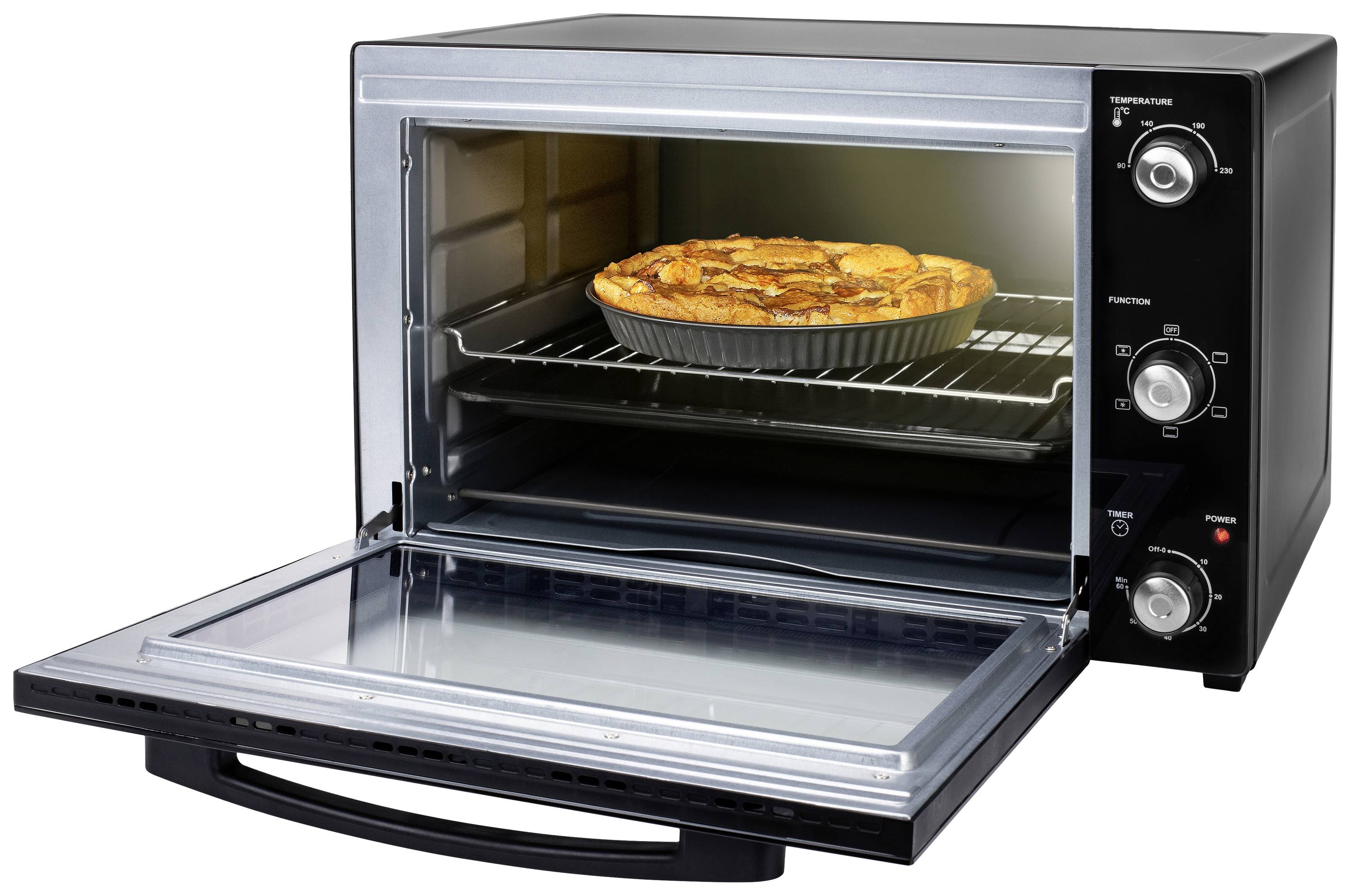 A black mini oven with its door open reveals a wire rack with a freshly baked, golden-brown apple cake.