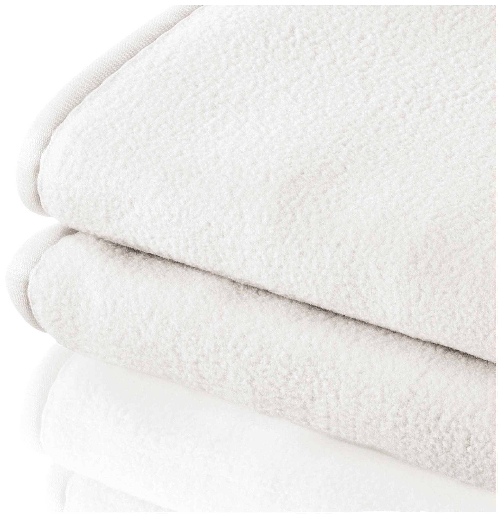 Stacked white towels made from soft, fluffy material.