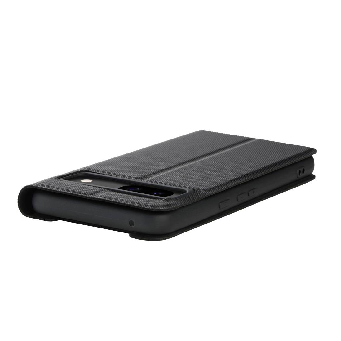 A smartphone in a black fold-over case, lying on a surface, with the camera visible.