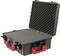 Black hard-shell suitcase with red handle, open with foam lining, suitable for secure transportation of delicate items.