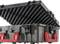 A sturdy plastic case with an open lid displays foam padding and red latches, suitable for secure transportation.