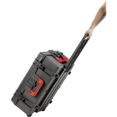A person is pulling a black, sturdy suitcase with red handles behind them by its extendable handle.