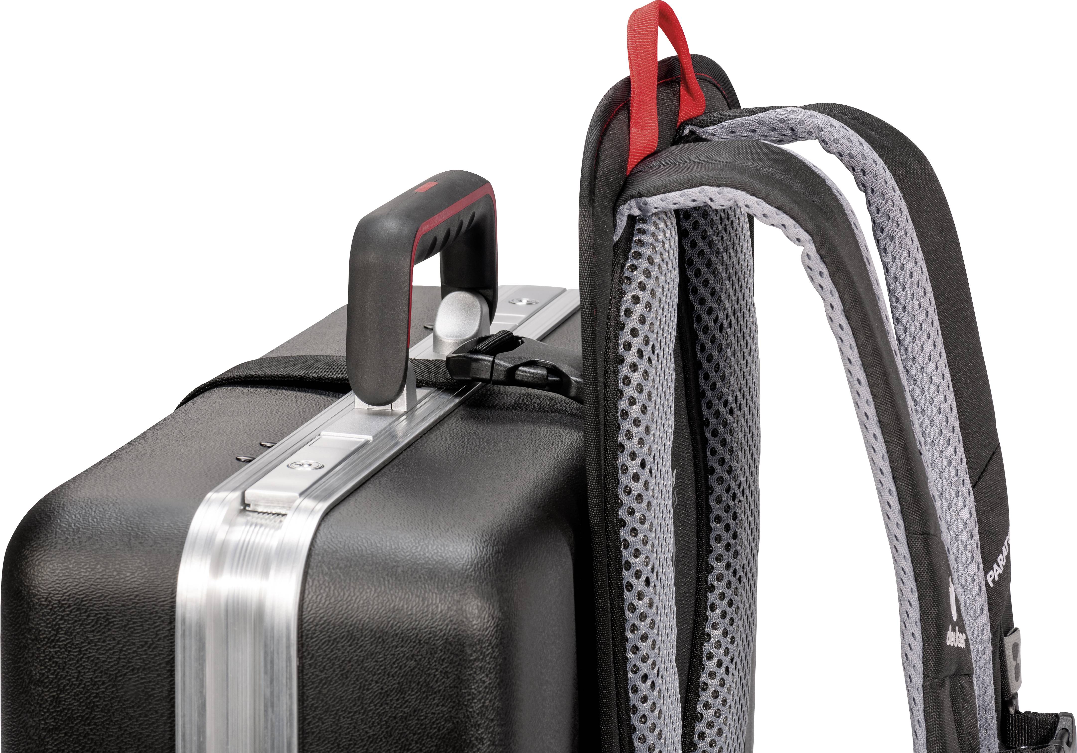 A black suitcase with an extendable handle is directly next to a grey rucksack.