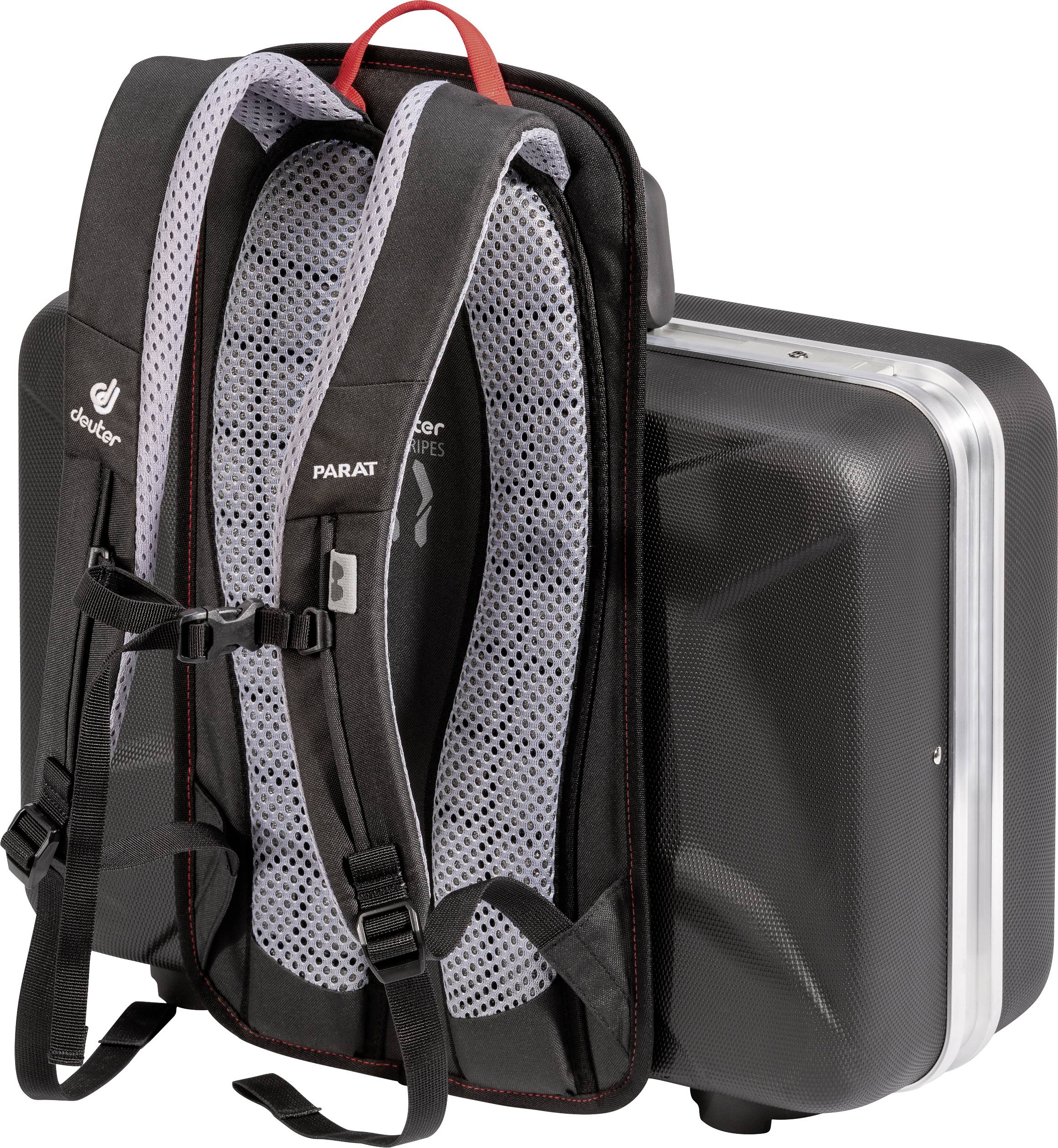A black rucksack with grey shoulder straps is attached to the back of a black, hard suitcase.