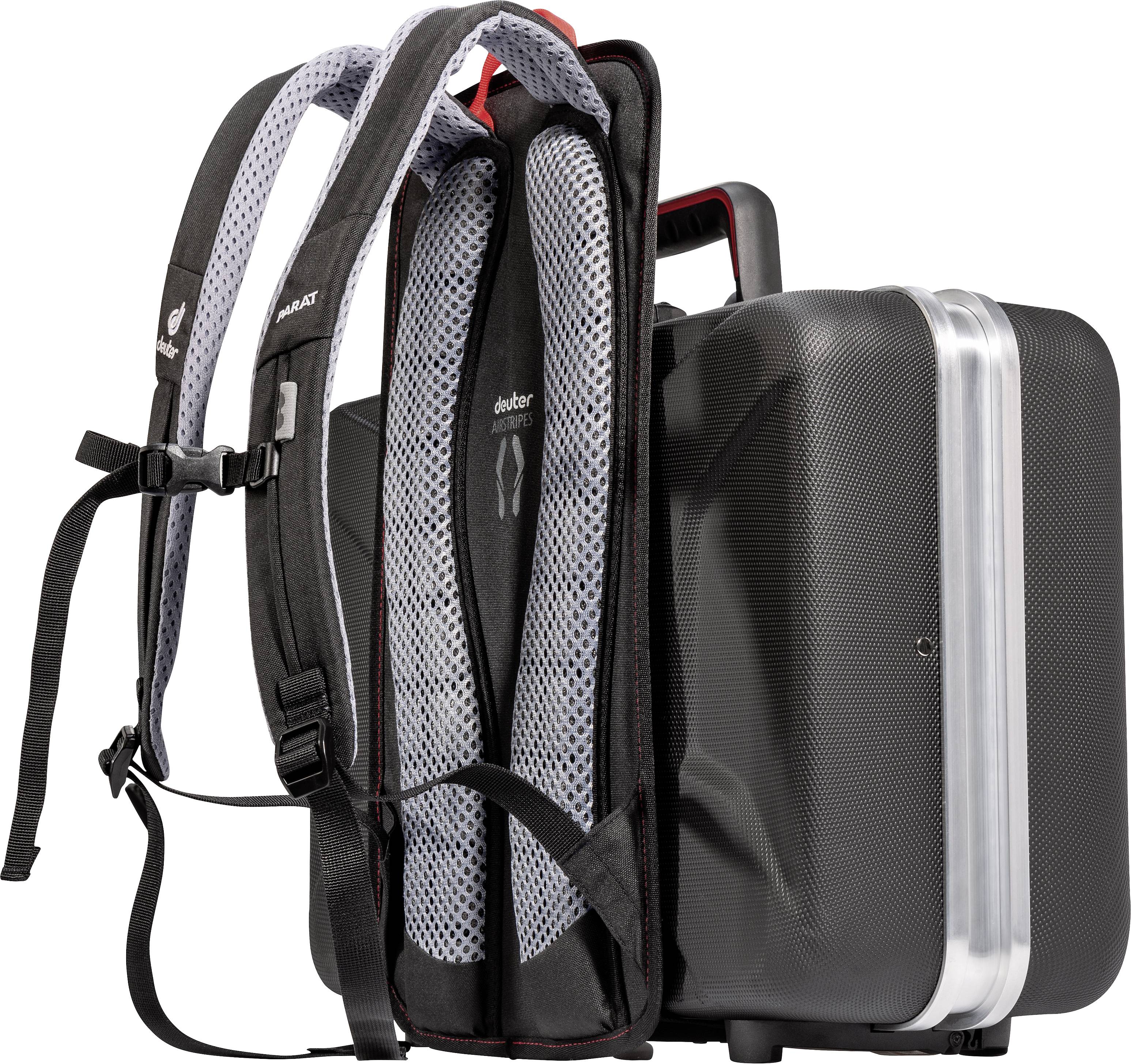 A black rucksack is attached to a black hard-shell suitcase. The suitcase has a silver frame.