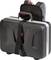 Hard-shell suitcase with a black strap and red handle mounted on a grey rucksack. Suitable for secure transportation.