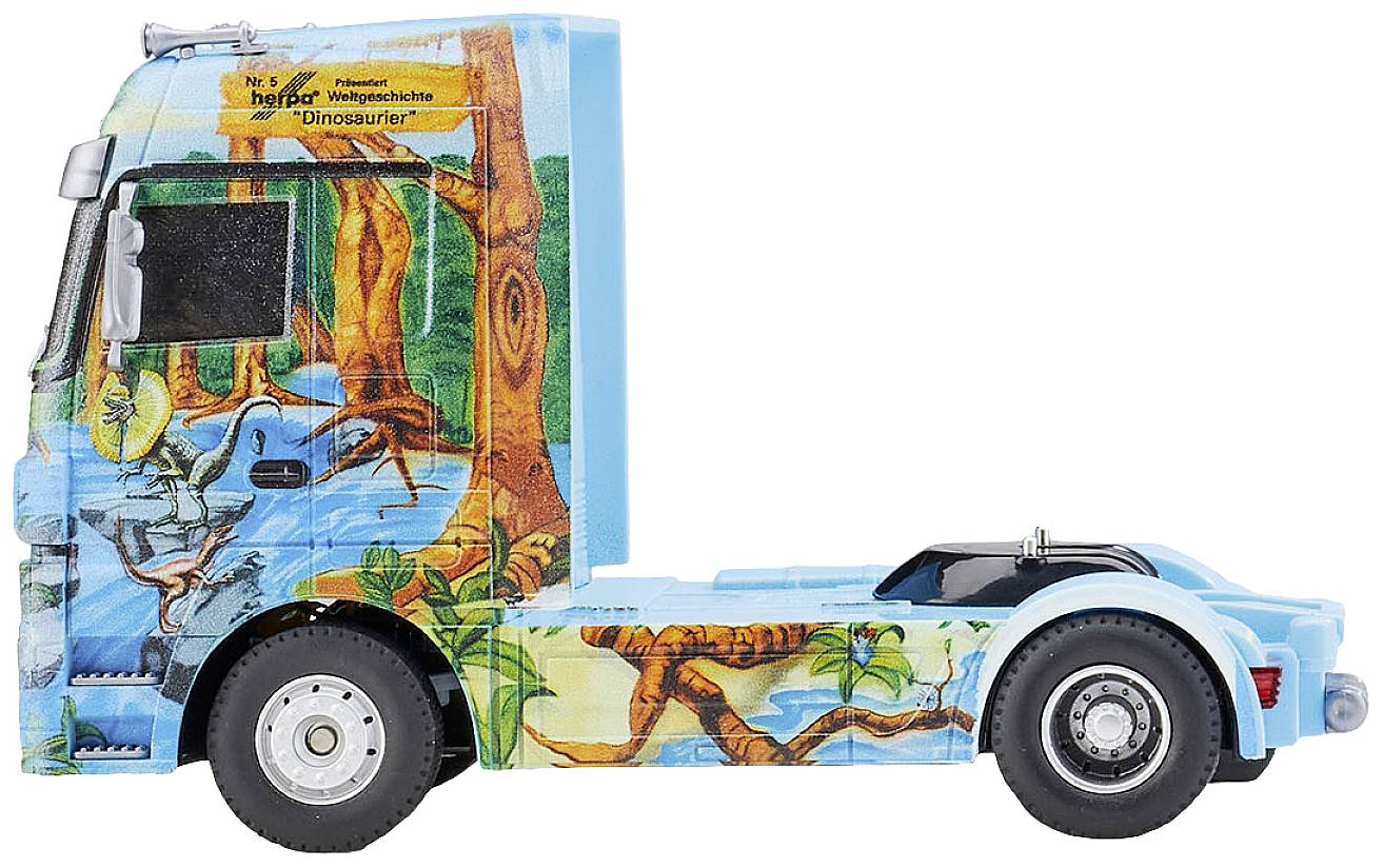 A blue model lorry with dinosaur and woodland motifs, number 6, is shown from the side.