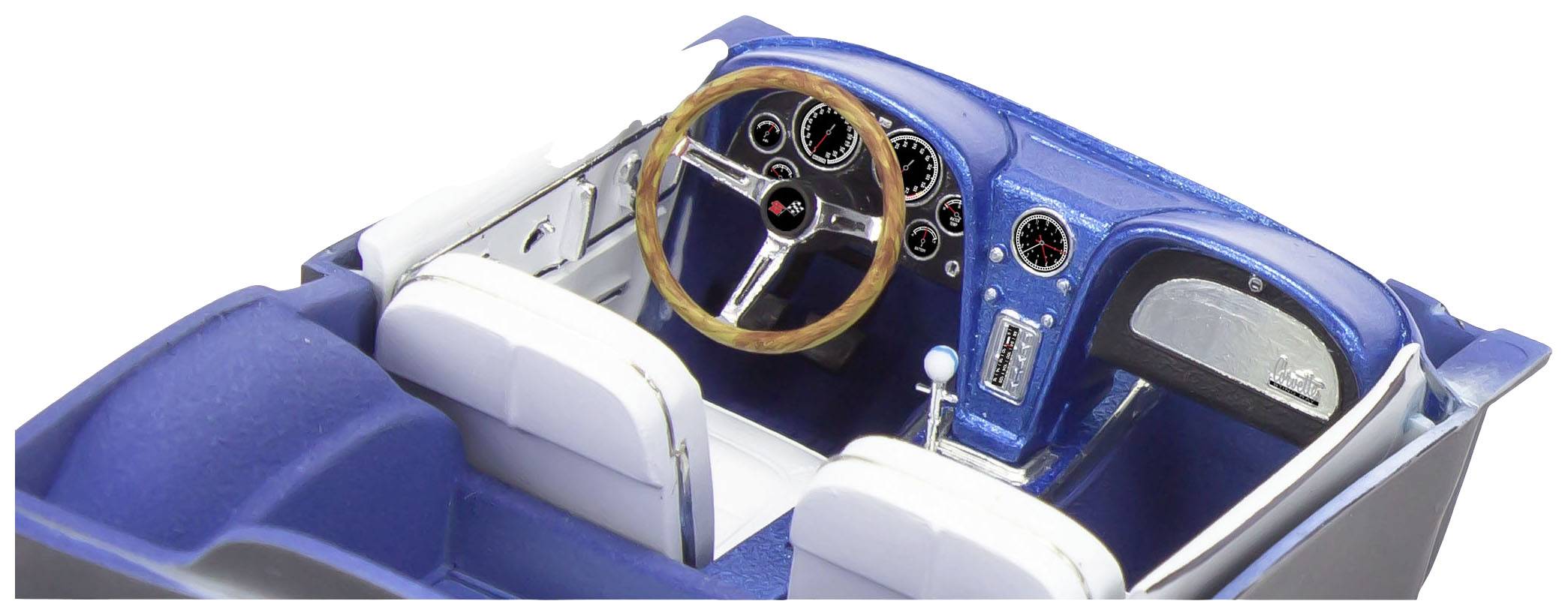 Interior view of a blue model car cockpit with a steering wheel, dashboard, and two white seats. The dashboard displays multiple dials.