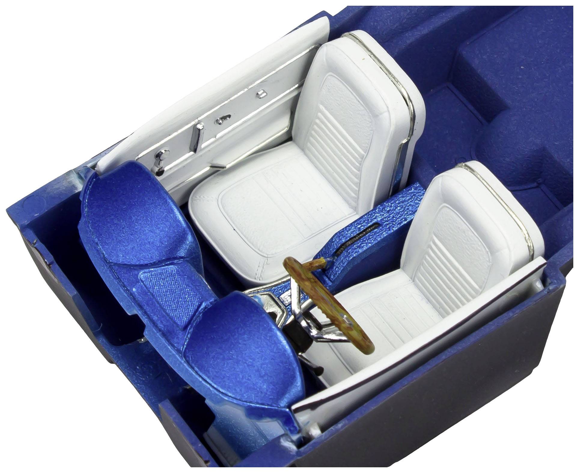 Miniature model of a blue vintage car interior with two white seats and a wooden steering wheel.
