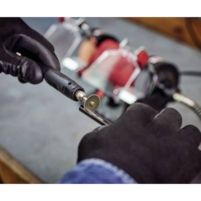 'A person is grinding a piece of metal with a rotating tool. Grinding wheel and hands in gloves are visible.'