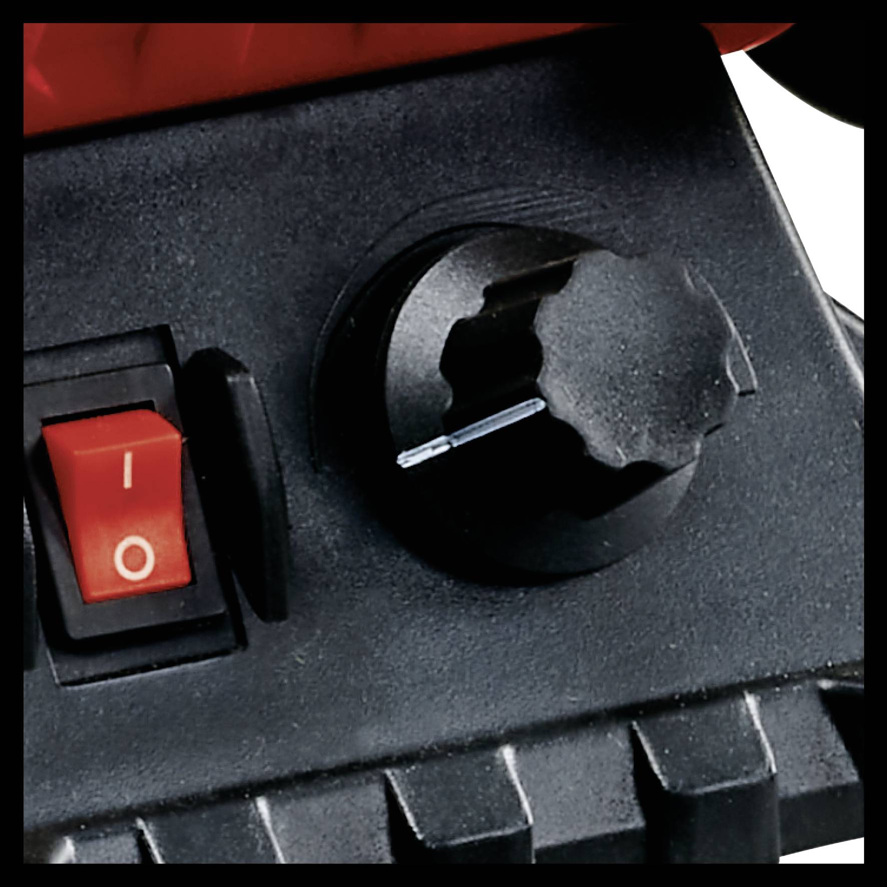 Close-up of a switch knob and a red power on/off switch on a black device.