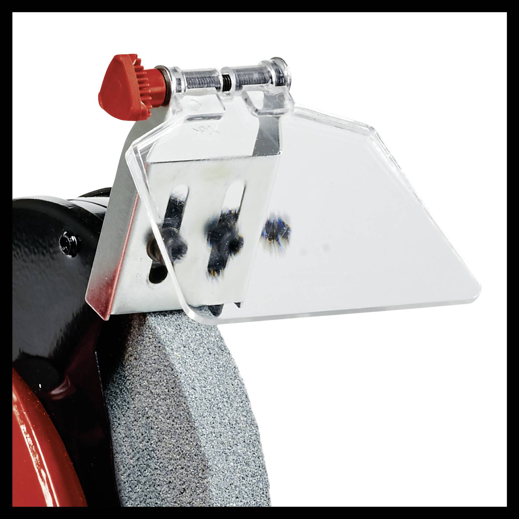 Close-up of a grinding machine with a protective shield and a grinding wheel, ready for sharpening or grinding tools.