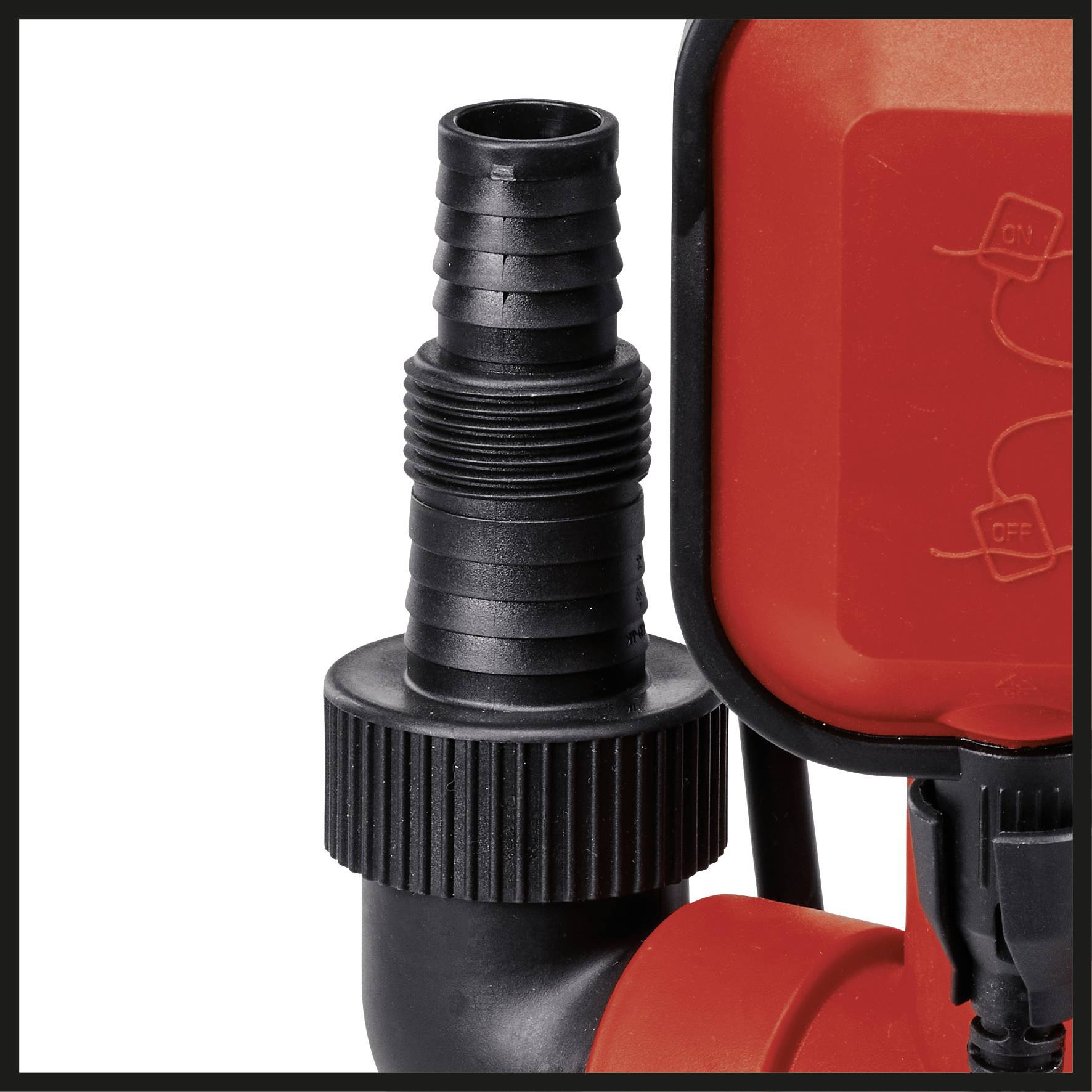 Close-up of a black plastic connector on a red device. The connector has a ribbed surface and is cylindrical in shape.