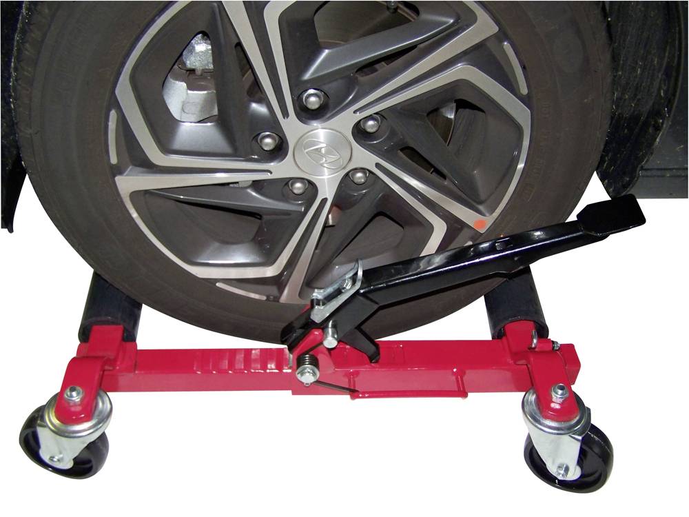 A tyre on a motor scooter. The scooter has red metal parts and black wheels to enable easy movement of the vehicle.