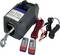 Electric winch with hook, cables and two remote controls, suitable for lifting heavy loads in a workshop environment.