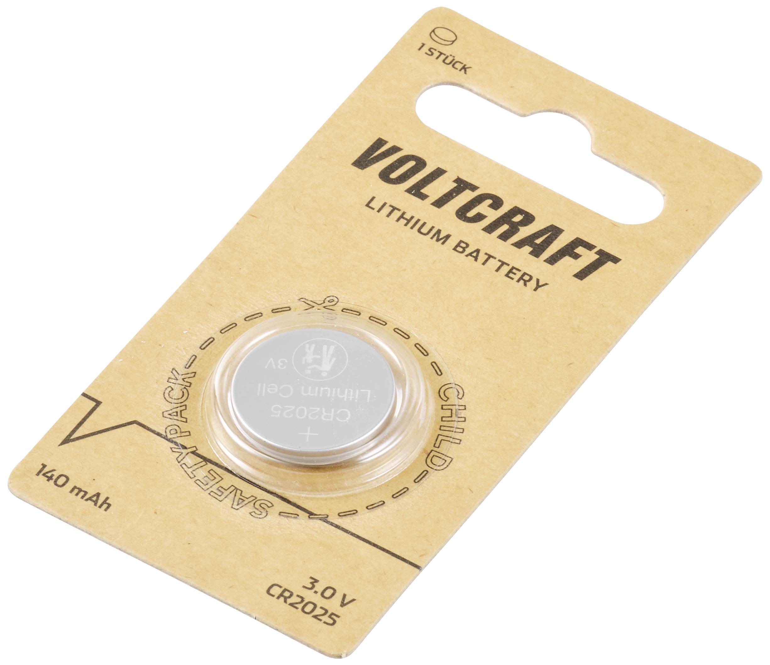 A Voltcraft brand lithium button cell battery, model CR2025, packaged on a cardboard box with safety information.