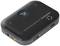 Black Bluetooth transmitter with power switch, AUX port and control buttons on the top surface.