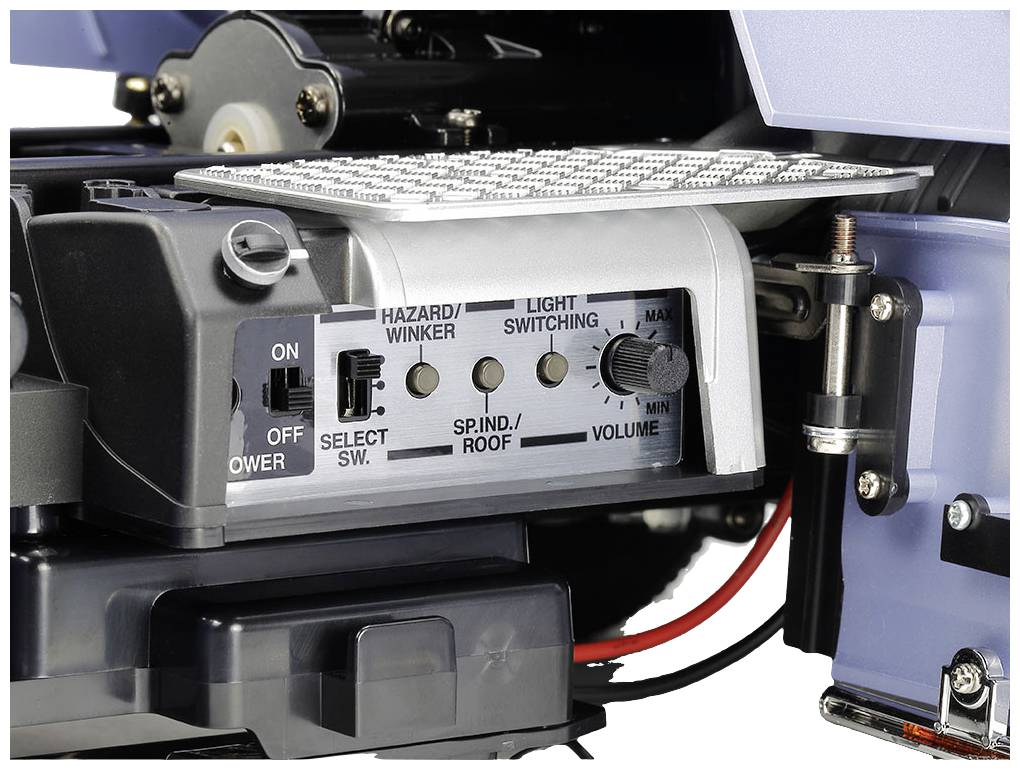 Close-up of a control panel with switches and rotary knobs labelled 'Hazard/Indicator', 'Light Switching' and 'Volume'.
